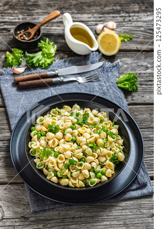 Pasta with green peas in a bowl, italian cuisine Pasta with green peas in a bowl, italian cuisine 125473295