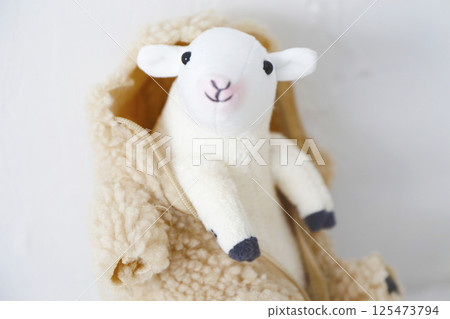 Stuffed sheep on a white background 125473794