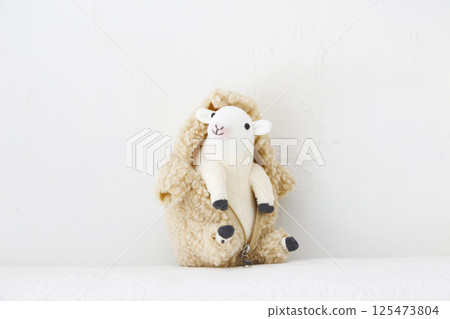 Stuffed sheep on a white background 125473804