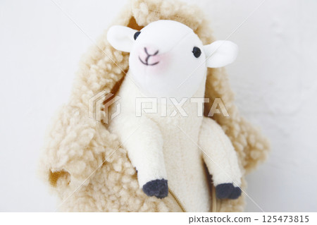 Stuffed sheep on a white background 125473815
