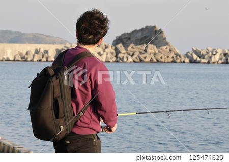 Man fishing at the fishing port 125474623