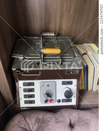 Vintage copying device. Antique photocopier. The equipment stands on a wooden shelf. Vintage copying device. Antique photocopier. The equipment stands on a wooden shelf. 125474707