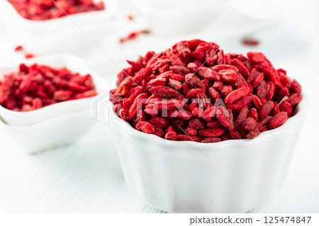 Dried goji berries on a white table. Dried goji berries on a white table. 125474847