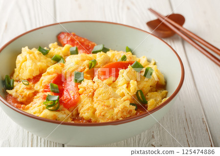 scrambled eggs with tomatoes, chinese food closeup on the plate. Horizontal scrambled eggs with tomatoes, chinese food closeup on the plate. Horizontal 125474886