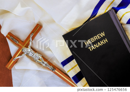24 April 2025 Jerusalem Israel Crucifix, Hebrew Tanakh are on tallit prayer shawl, reflecting Messianic Jewish Congregation of religious traditions. 125476656
