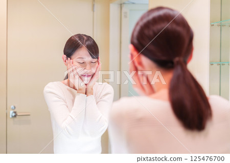 A middle-aged woman getting ready before going out A middle-aged woman getting ready before going out 125476700