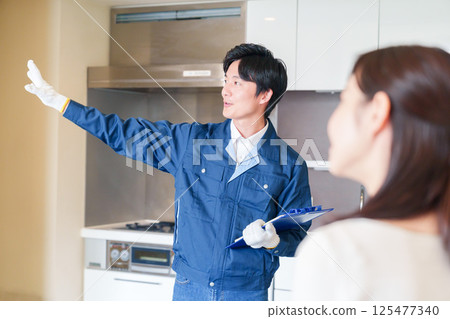A man inspecting apartments by visiting each apartment 125477340