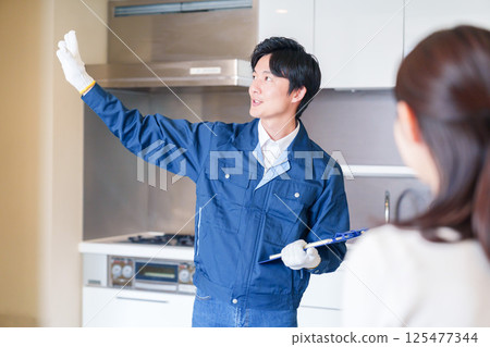 A man inspecting apartments by visiting each apartment 125477344