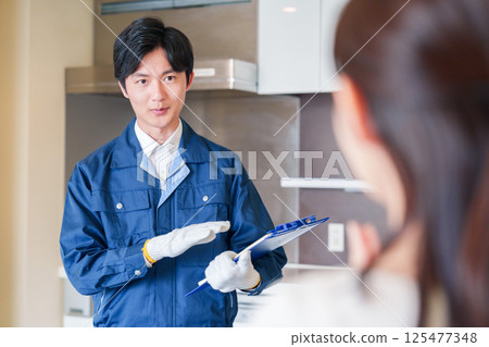 A man inspecting apartments by visiting each apartment 125477348