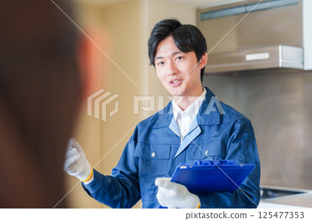 A man inspecting apartments by visiting each apartment 125477353