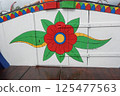 Colorful flower painted on a wooden wall 125477563