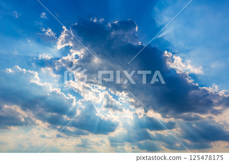 Dramatic cloudy sky clouds with real sun beams 125478175