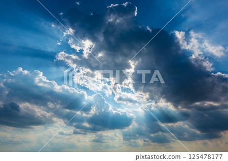 Dramatic cloudy sky clouds with real sun beams 125478177