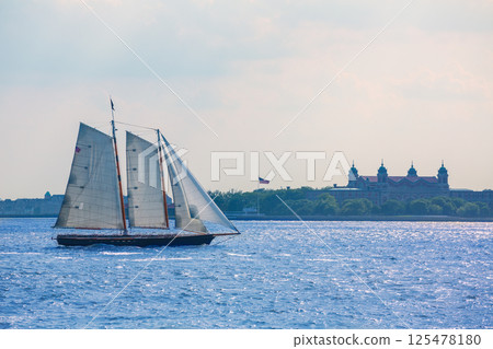 New York sailboat sunset and Ellis Island New York sailboat sunset and Ellis Island 125478180