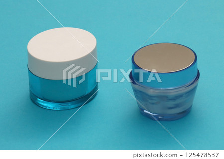 Blue face cream glass jars 125478537
