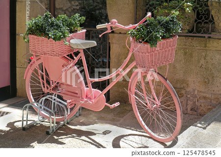 Pink bicycle in city Pink bicycle in city 125478545