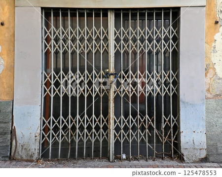 Closed door with locked gate Closed door with locked gate 125478553