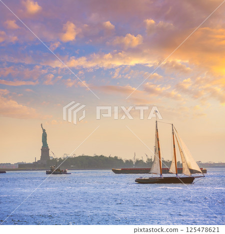 New York sailboat sunset and Statue of Liberty 125478621