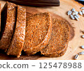 Homemade sunflower halva sliced on wooden background 125478988