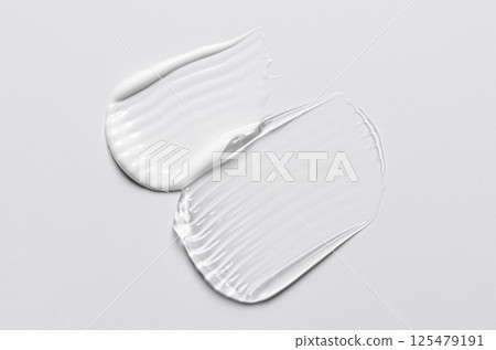 A sample of white and transparent cosmetic cream 125479191