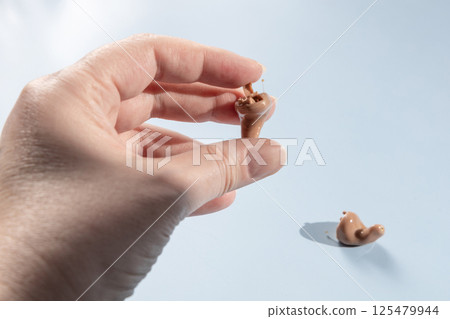 Female hand holding modern hearing aid 125479944