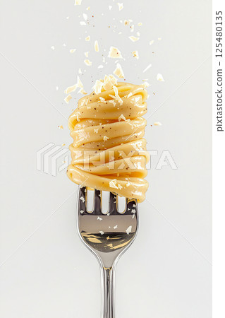 Creamy Pasta Twirled on Fork with Cheese Shavings 125480135