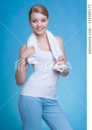 Woman with a towel around her shoulders smiling 125480175