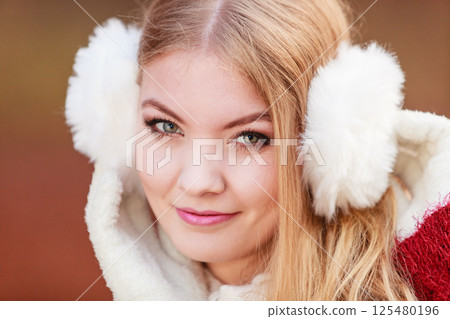 Portrait of pretty gorgeous woman in earmuffs. 125480196