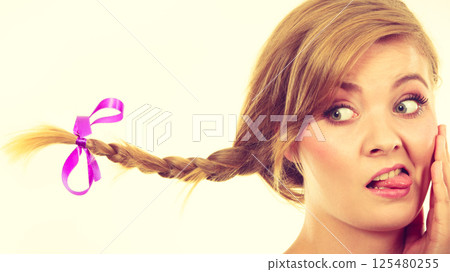 Teenage girl in braid hair making funny face 125480255
