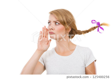 Teenage girl in braid hair talking rumors Teenage girl in braid hair talking rumors 125480256