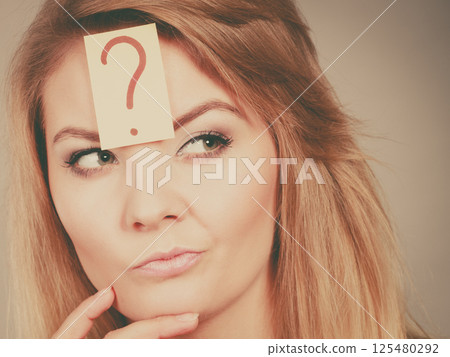 Closeup of woman thinking face expression Closeup of woman thinking face expression 125480292