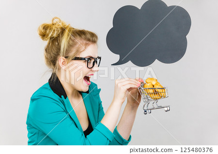 Bussines woman holding shopping cart with sweet bun 125480376