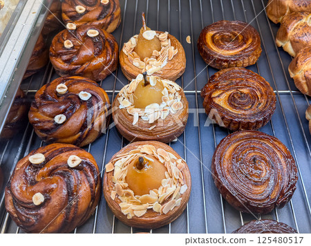 Assorted gourmet desserts in bakery display. Variety and modern pastry aesthetics Assorted gourmet desserts in bakery display. Variety and modern pastry aesthetics 125480517
