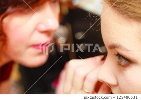 Close up woman getting make up, eyeshadow Close up woman getting make up, eyeshadow 125480531
