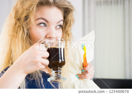 Funny woman being late drinking coffee 125480678