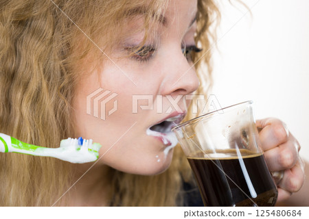 Funny woman being late drinking coffee 125480684