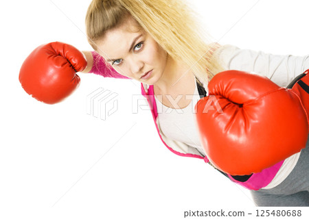 Woman wearing boxing gloves 125480688