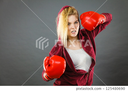 Woman wearing boxing gloves Woman wearing boxing gloves 125480690