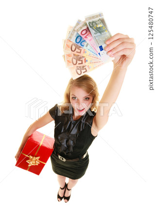 Woman with gift box and euro currency money banknotes. 125480747