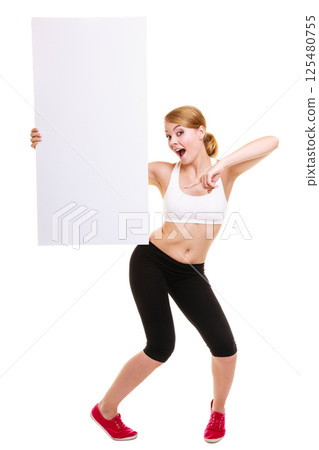 Fitness sporty woman holding blank empty ad banner Fitness sporty woman holding blank empty ad banner 125480755