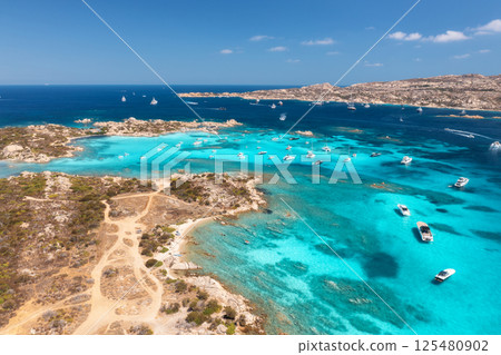 Aerial view of luxury yachts and boats on blue sea, island 125480902