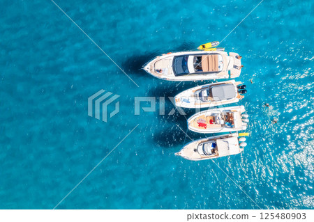 Aerial view of luxury yacht and boat in blue sea in summer 125480903