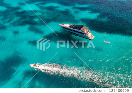 Aerial view of luxury yacht and boat in blue sea in summer 125480909