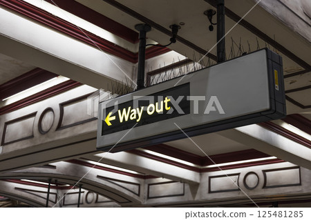 Illuminated Way Out Sign Hanging Inside Historic Train Station Ceiling Interior 125481285