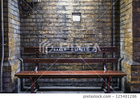 Vintage Wooden Bench Against Exposed Brick Wall at Baker Street Station Interior Vintage Wooden Bench Against Exposed Brick Wall at Baker Street Station Interior 125481286
