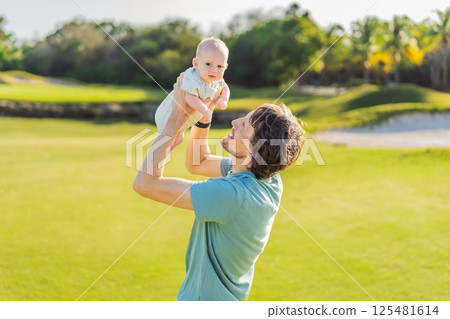 Father and newborn baby on a meadow in the park. Tender moment of bonding and love in nature. Parenthood, fatherhood, and family connection concept Father and newborn baby on a meadow in the park. Tender moment of bonding and love in nature. Parenthood, fatherhood, and family connection concept 125481614