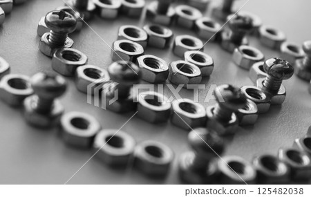 Concentric Pattern Of Circles Lined With Nuts And Inserted Through Equal Lengths Of Threaded Bolts. Monochrome Detailed Image For Mechanical Hardware Backgrounds  125482038