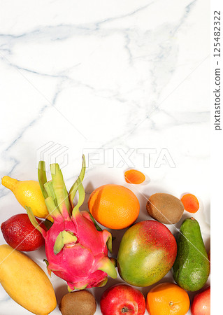 Dragon fruit, pitaya, mango, kiwi, avacado, apples, citrus and dried apricots on a sunny table with space for text. Healthy vegan food for weight loss. Banner with tropical exotic fruits and juice Dragon fruit, pitaya, mango, kiwi, avacado, apples, citrus and dried apricots on a sunny table with space for text. Healthy vegan food for weight loss. Banner with tropical exotic fruits and juice 125482322
