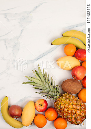 Detox diet and weight loss concept. Summer tropical fruits on marble table, source of vitamin C, store banner, healthy vegan products for healthy lifestyle, store advertisement. Detox diet and weight loss concept. Summer tropical fruits on marble table, source of vitamin C, store banner, healthy vegan products for healthy lifestyle, store advertisement. 125482328
