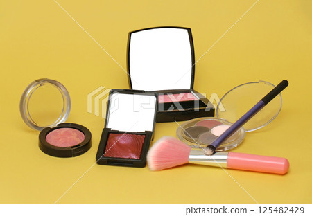 Makeup on yellow background 125482429